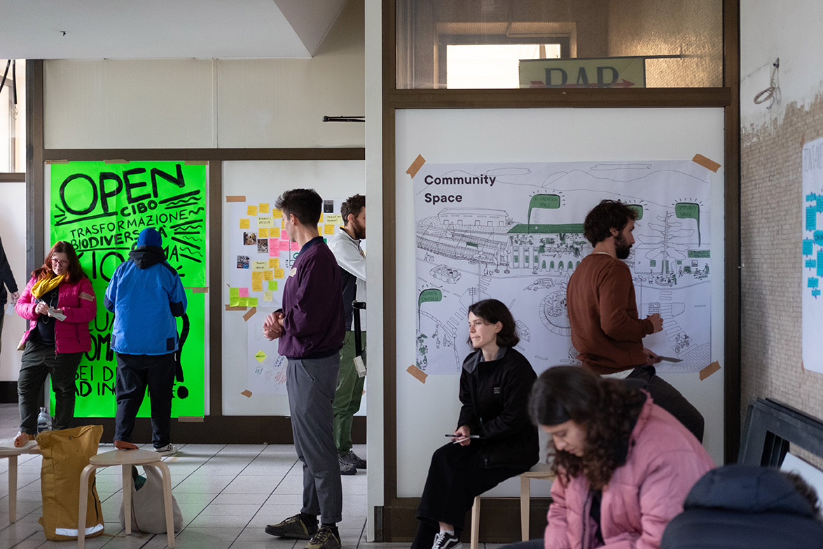 People reading and writing notes inside one of the S4T spaces at the train station of Rovereto.