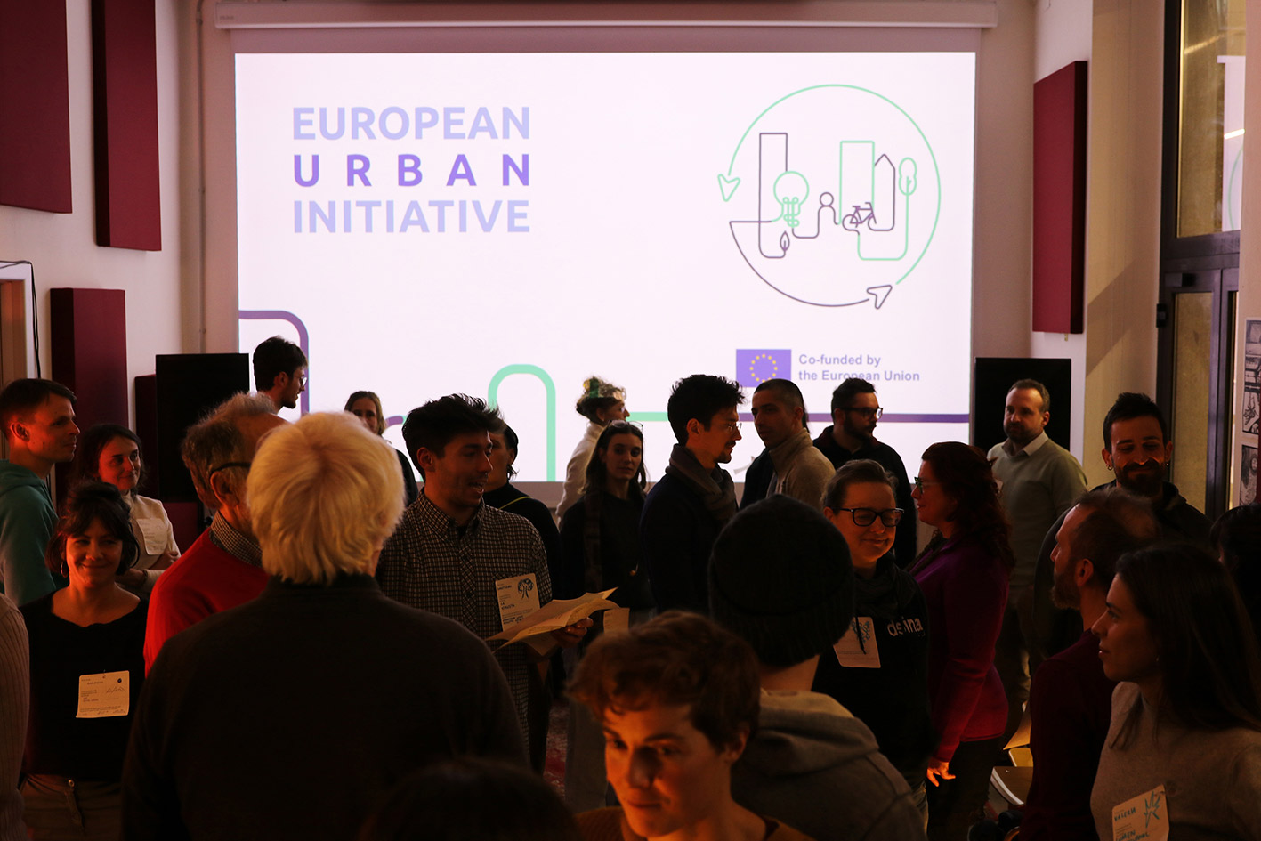 A room filled with people participating in a Station for Transformation co-design event.