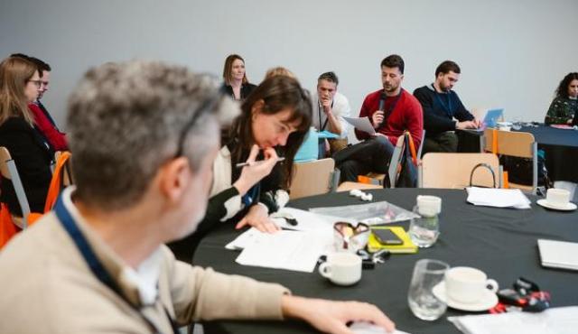 workshop around round table, cooperating peole