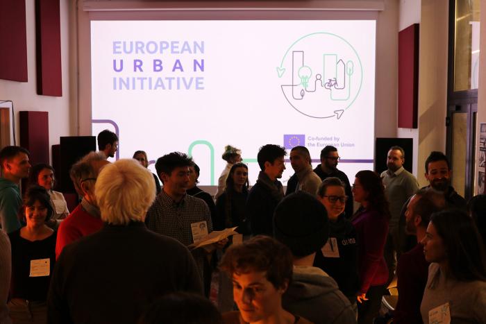 A room filled with people participating in a Station for Transformation co-design event.