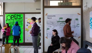 People reading and writing notes inside one of the S4T spaces at the train station of Rovereto.